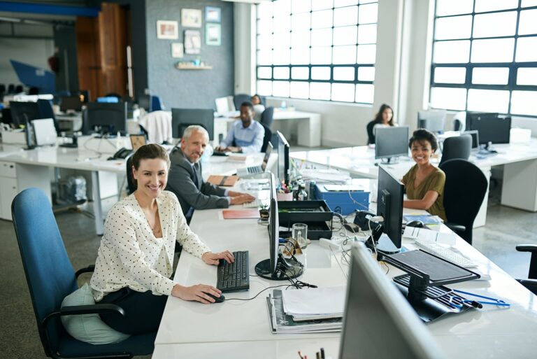 portrait-of-a-group-of-coworkers-sitting-at-their