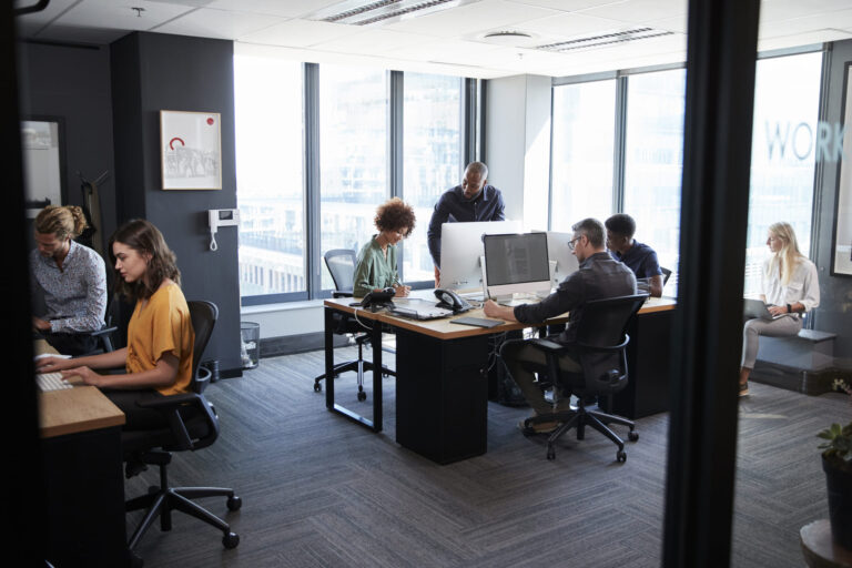 young-creative-team-working-together-at-computers