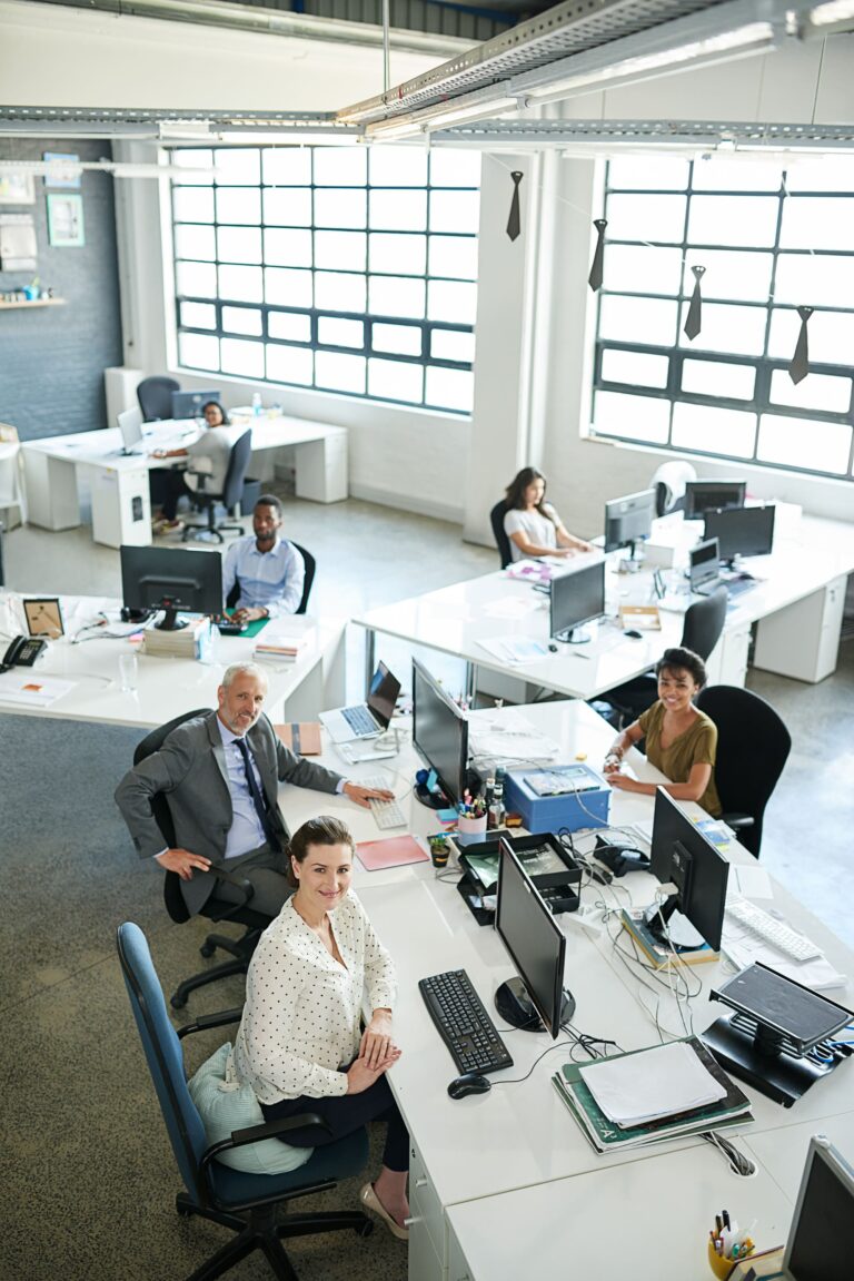 portrait-of-a-group-of-coworkers-sitting-at-their